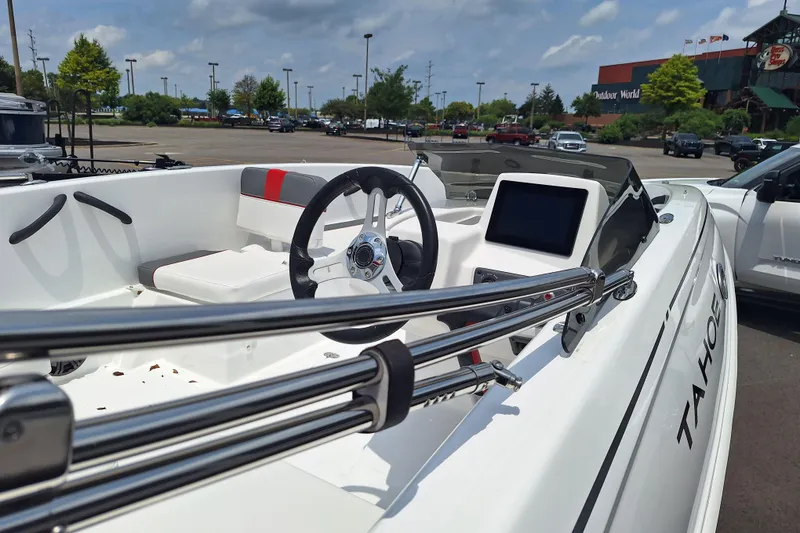 Slide: The Image of 2026 Tahoe T18 boat interior with steering wheel and dashboard in a parking lot. - 4