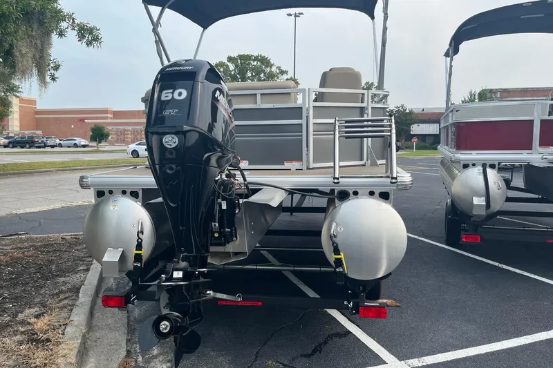 Slide: The Image of 2025 Sun Tracker Party Barge 20 DLX pontoon boat with Mercury 60 HP engine in parking lot. - 5