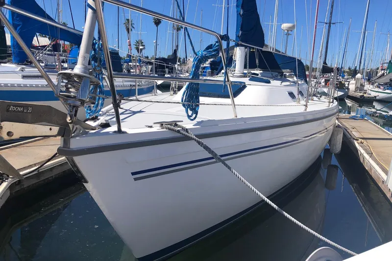 The Image of 1994 Catalina 36 MkII sailboat docked in marina, featuring sleek white hull and blue accents. - 0