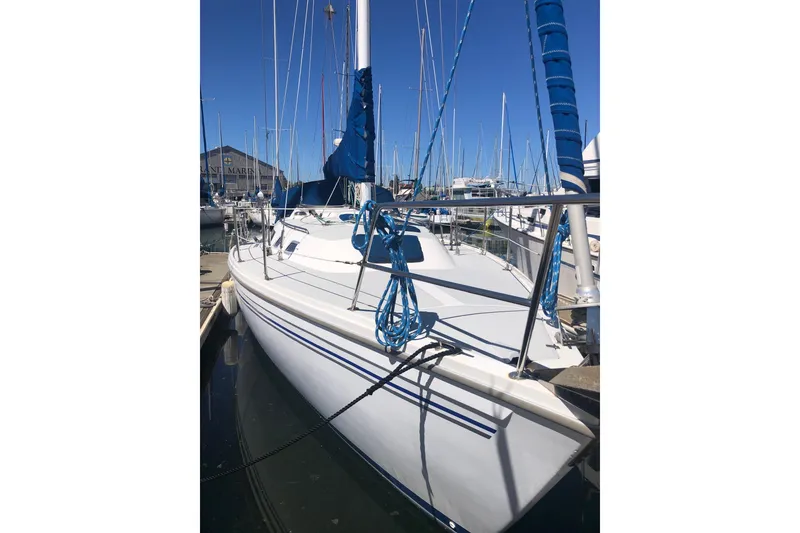 Slide: The Image of 1994 Catalina 36 MkII sailboat docked at marina, featuring blue rigging and white hull. - 13
