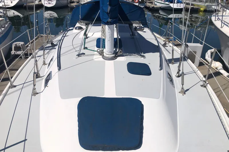 Slide: The Image of 1994 Catalina 36 MkII sailboat deck view in marina, featuring blue covers and rigging. - 17