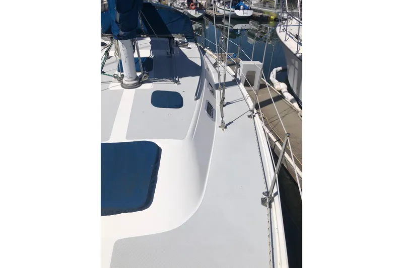 Slide: The Image of 1994 Catalina 36 MkII sailboat deck view at marina, showcasing sleek design and rigging. - 19