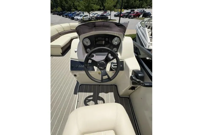 Slide: The Image of 2022 Lexington 623 boat dashboard with steering wheel and seating area. - 8