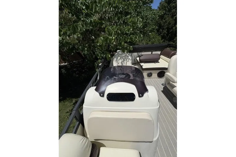 Slide: The Image of 2022 Lexington 623 pontoon boat interior with beige seating and black accents. - 9