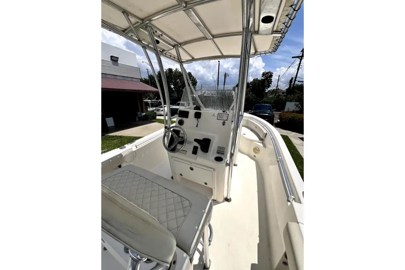 Slide: The Image of 2019 Cobia 220 Center Console boat interior with steering wheel and seating. - 13