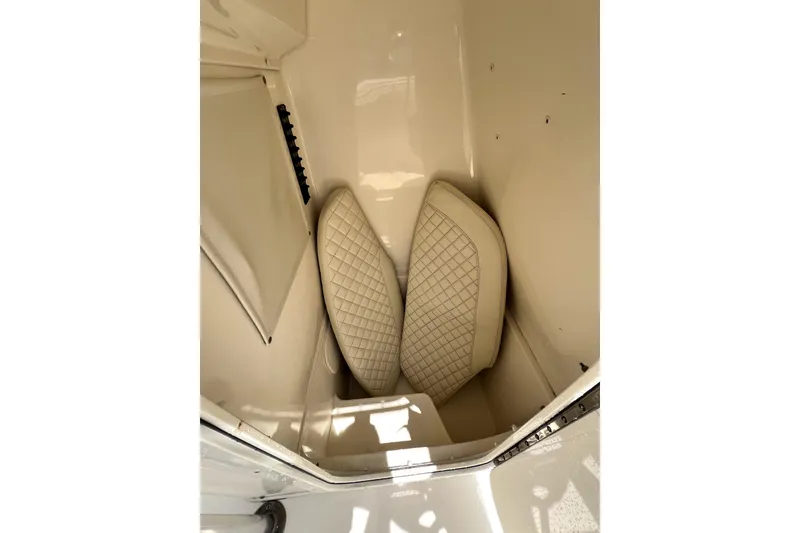 Slide: The Image of 2019 Cobia 220 Center Console storage compartment with cushioned interior. - 16
