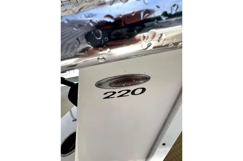 Slide: The Image of Close-up of 2019 Cobia 220 Center Console boat with water droplets. - 17