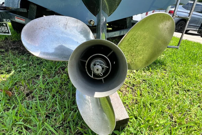 Slide: The Image of Propeller of 2019 Cobia 220 Center Console boat on grass. - 20