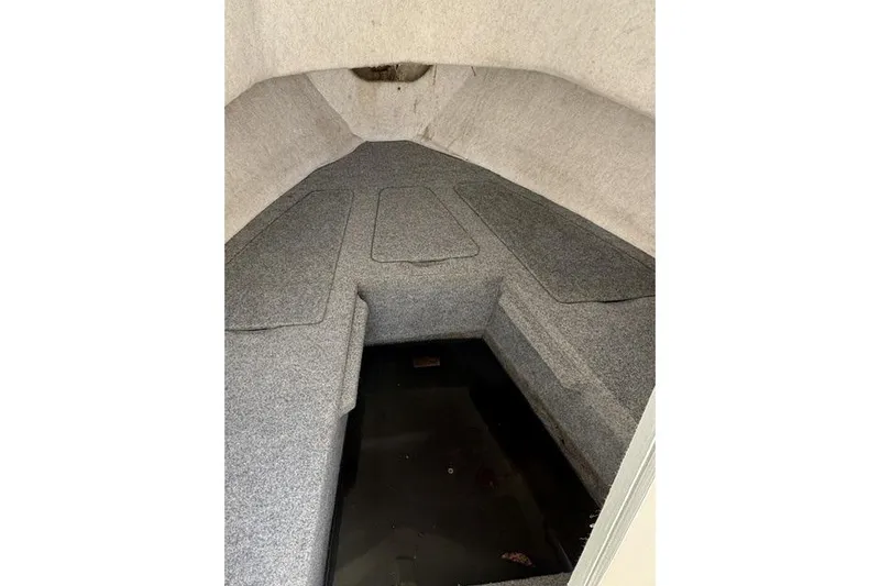 Slide: The Image of Interior cabin of a 2006 Trophy 1802 Walkaround boat, showing carpeted seating area. - 5