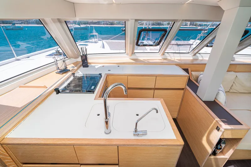 Slide: The Image of Modern kitchen interior on a 2019 Nautitech 46 Open catamaran, featuring sleek design and ocean views. - 18