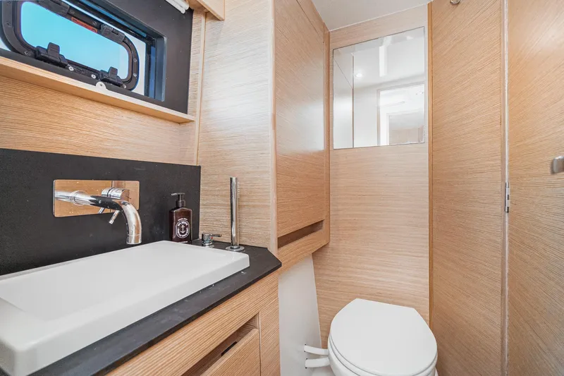 Slide: The Image of Modern bathroom interior of 2019 Nautitech 46 Open yacht, featuring sleek wood finishes. - 41