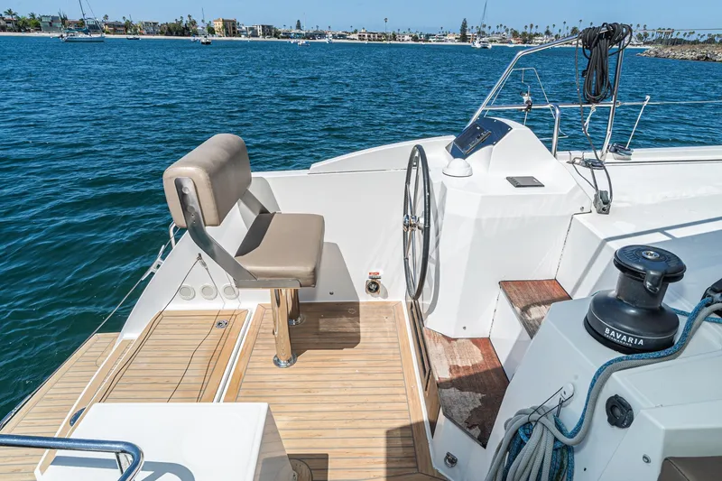 Slide: The Image of 2019 Nautitech 46 Open yacht helm with ocean view, featuring steering wheel and seating. - 23