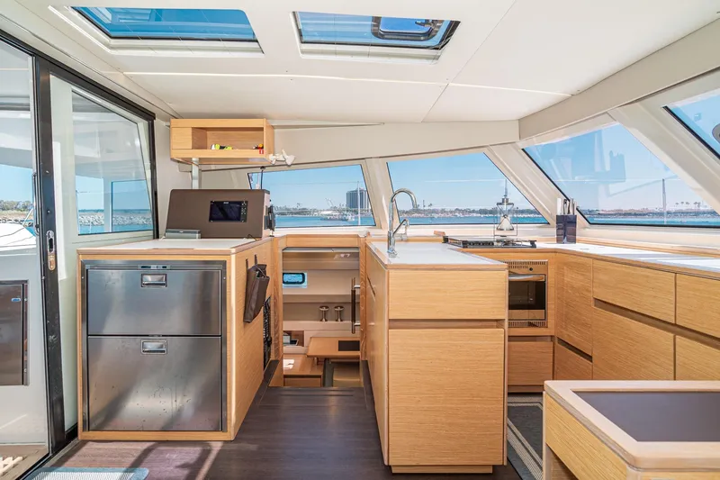Slide: The Image of Modern interior of 2019 Nautitech 46 Open catamaran with sleek kitchen design and panoramic windows. - 15