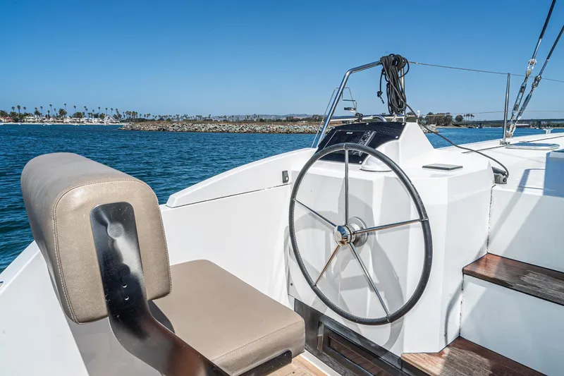 Slide: The Image of Steering wheel of 2019 Nautitech 46 Open catamaran with ocean view. - 24
