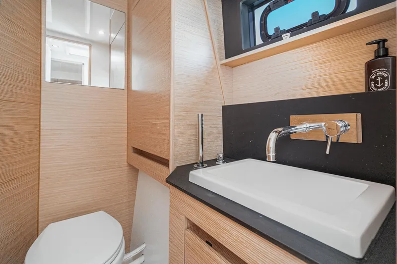 Slide: The Image of Modern bathroom interior on 2019 Nautitech 46 Open yacht, featuring sleek sink and wooden accents. - 43