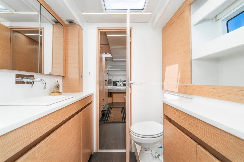Slide: The Image of Modern bathroom interior on 2019 Nautitech 46 Open catamaran, featuring sleek wood cabinetry. - 35
