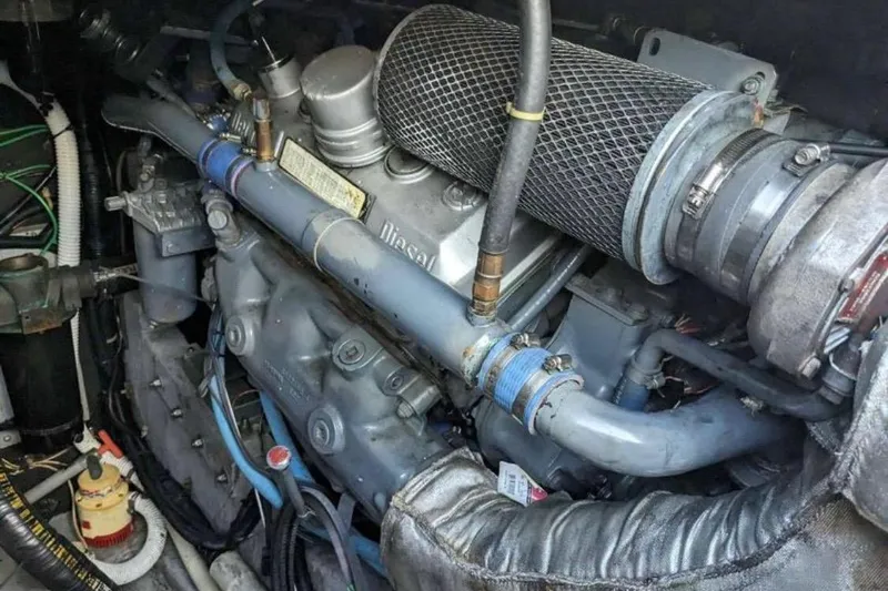 Slide: The Image of Engine compartment of a 1988 Sea Ray Sundancer 460, showcasing diesel engine components. - 10