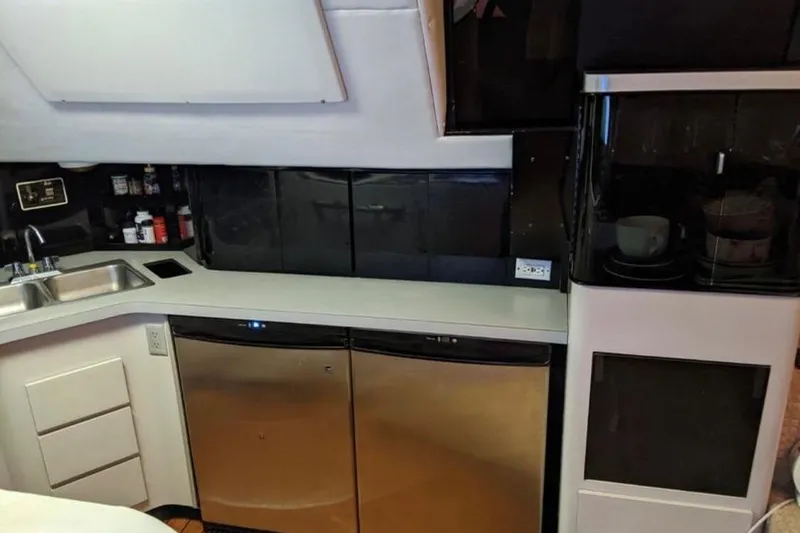 Slide: The Image of Galley kitchen in 1988 Sea Ray Sundancer 460 yacht with stainless steel appliances. - 6