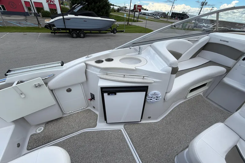 Slide: The Image of 2015 Glastron GS 289 boat interior with seating, sink, and mini fridge. - 10
