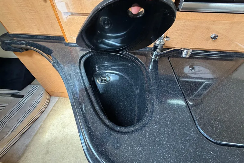 Slide: The Image of 2015 Glastron GS 289 boat interior with sleek black sink and faucet. - 19