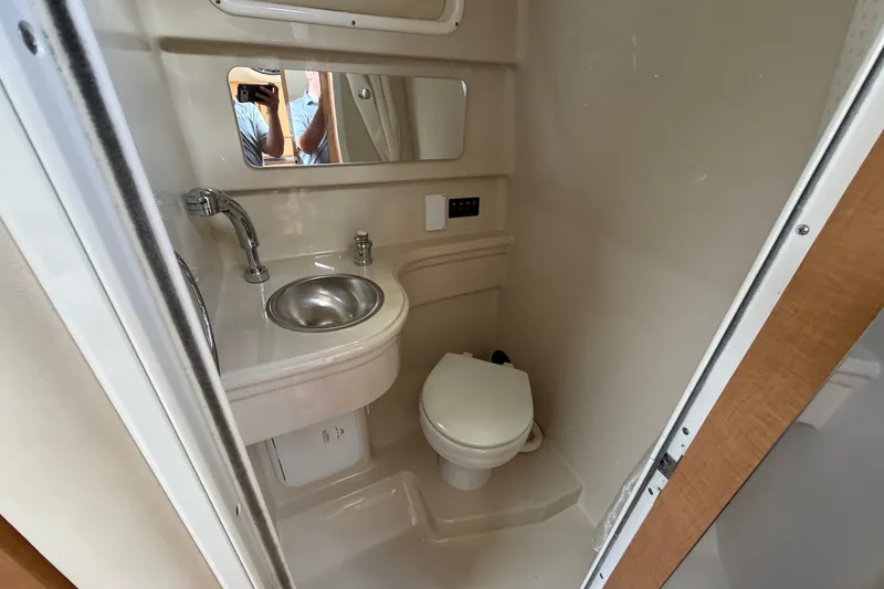 Slide: The Image of Compact bathroom in 2015 Glastron GS 289 boat with sink, toilet, and mirror. - 22