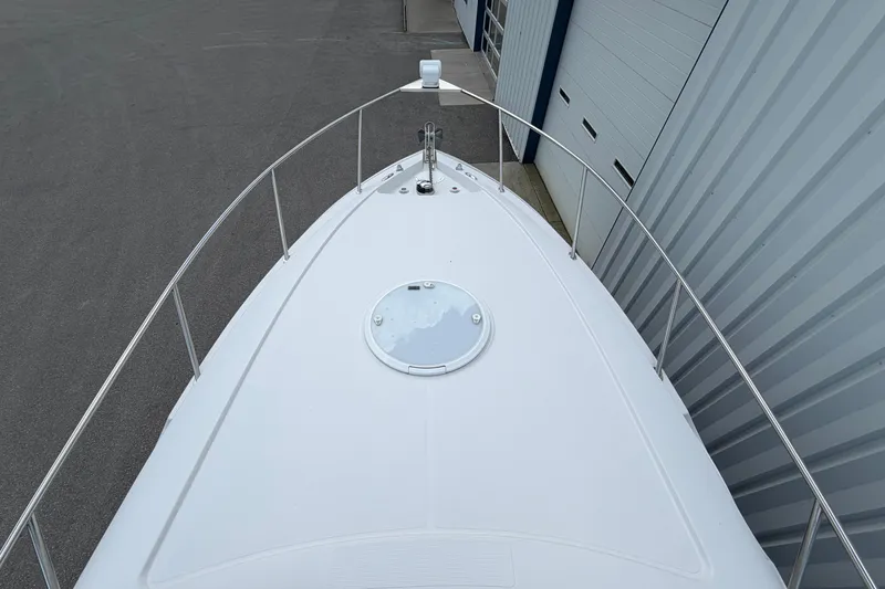 Slide: The Image of 2015 Glastron GS 289 boat bow view, docked near a building. - 23