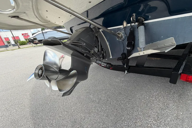 Slide: The Image of 2015 Glastron GS 289 boat propeller and stern drive in a parking lot. - 26
