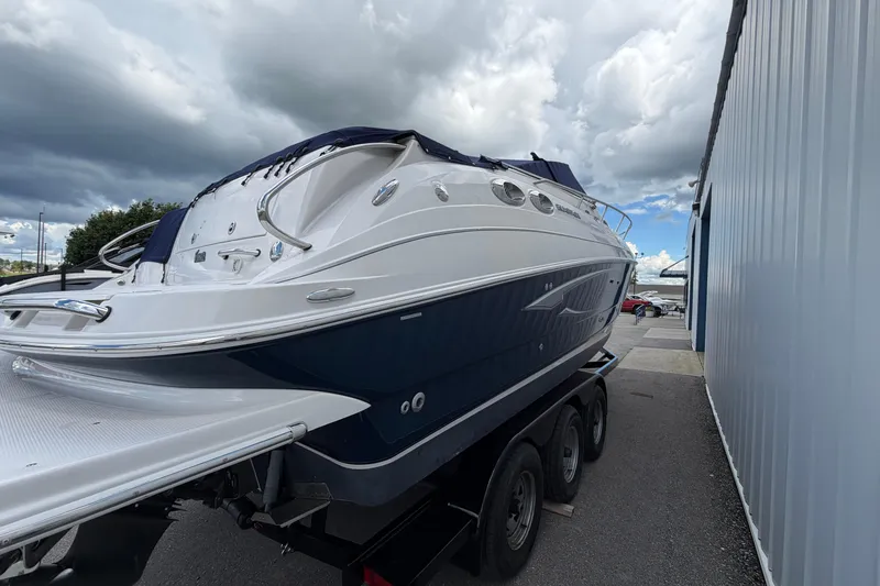 Slide: The Image of 2015 Glastron GS 289 boat on trailer under cloudy sky. - 5
