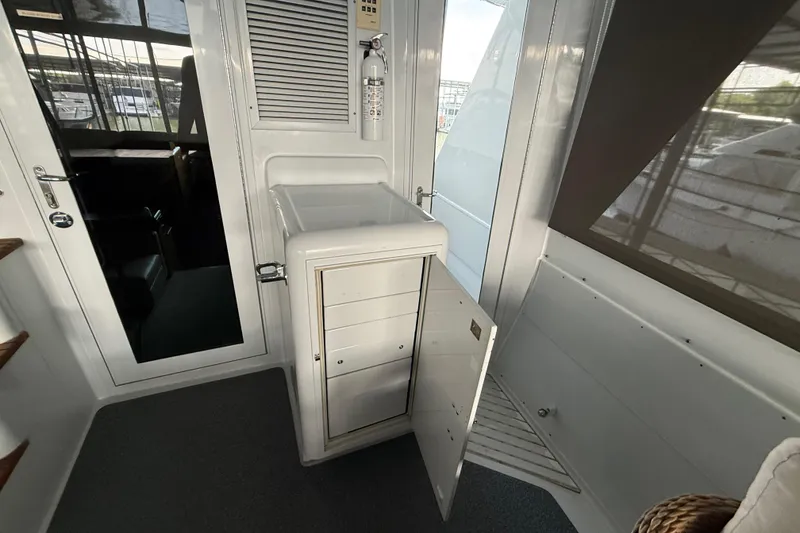 Slide: The Image of Interior of a 1998 Hatteras yacht featuring a storage compartment and door. - 21