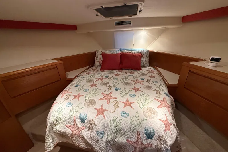 Slide: The Image of Cozy bedroom in a 1998 Hatteras yacht with starfish-themed bedding. - 32