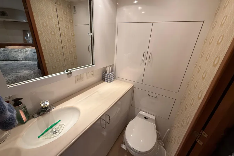Slide: The Image of Bathroom interior of a 1998 Hatteras yacht with modern fixtures and cabinetry. - 43