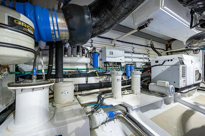 Slide: The Image of Engine room of 2014 Marlow 80 Explorer yacht, showcasing advanced mechanical systems. - 100