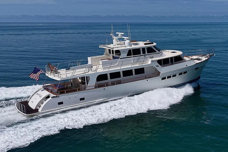 Slide: The Image of Luxurious 2014 Marlow 80 Explorer yacht cruising on open sea with American flag. - 104