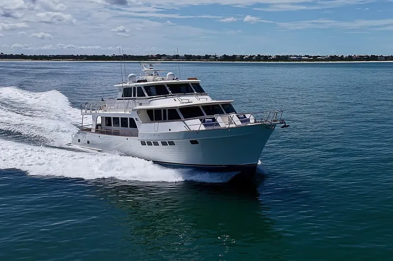 Slide: The Image of 2014 Marlow 80 Explorer yacht cruising on open water under a clear sky. - 106