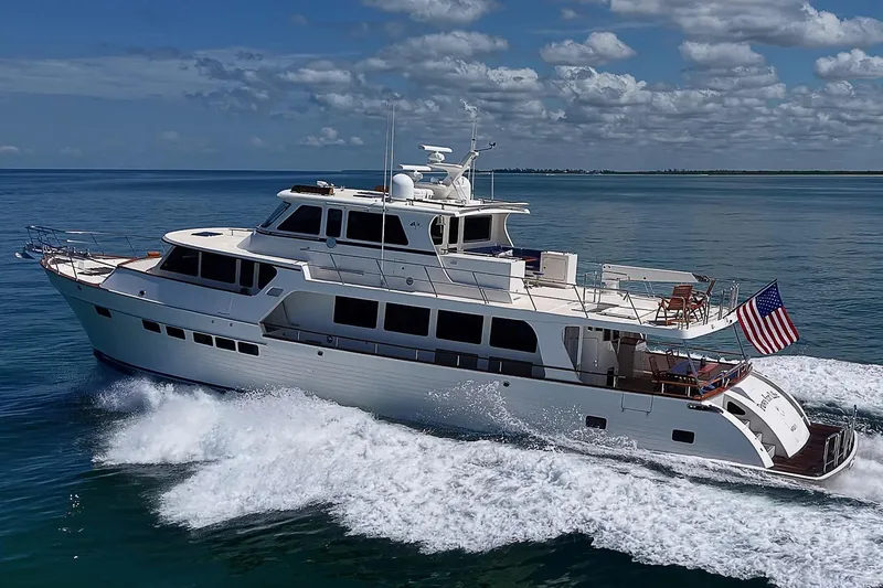 Slide: The Image of 2014 Marlow 80 Explorer yacht cruising on open water under a partly cloudy sky. - 109