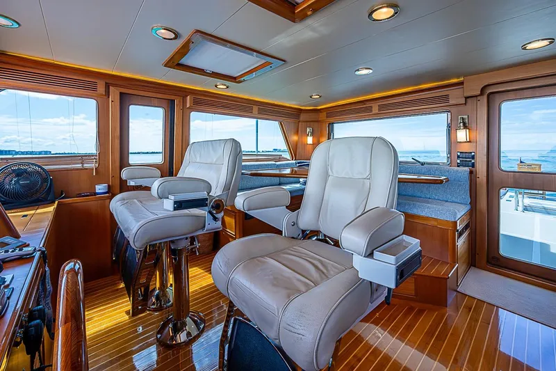 Slide: The Image of Luxurious interior of 2014 Marlow 80 Explorer yacht with plush seating and panoramic windows. - 11