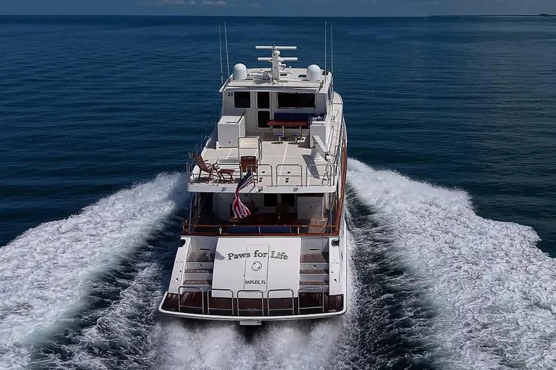 Slide: The Image of 2014 Marlow 80 Explorer yacht cruising on open water, rear view. - 110
