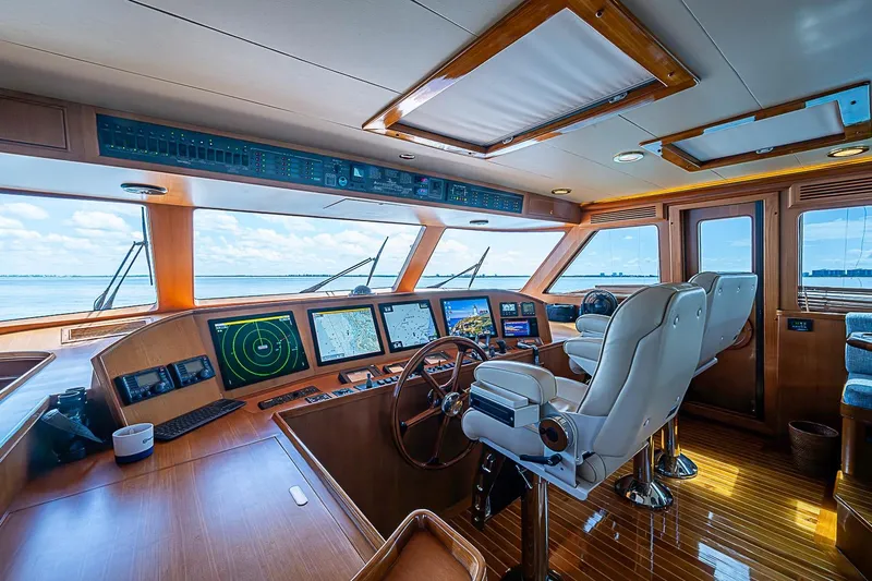 Slide: The Image of Luxurious 2014 Marlow 80 Explorer yacht cockpit with advanced navigation systems and plush seating. - 12