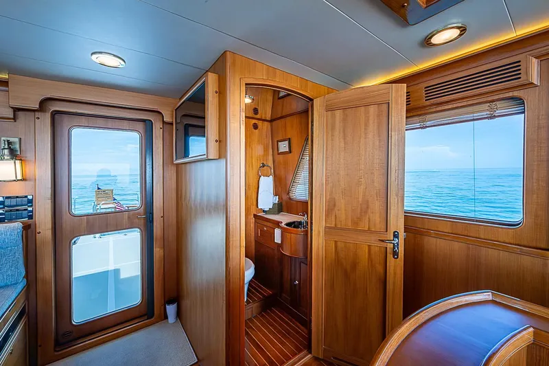 Slide: The Image of Luxurious 2014 Marlow 80 Explorer yacht interior with wooden finishes and ocean view. - 13