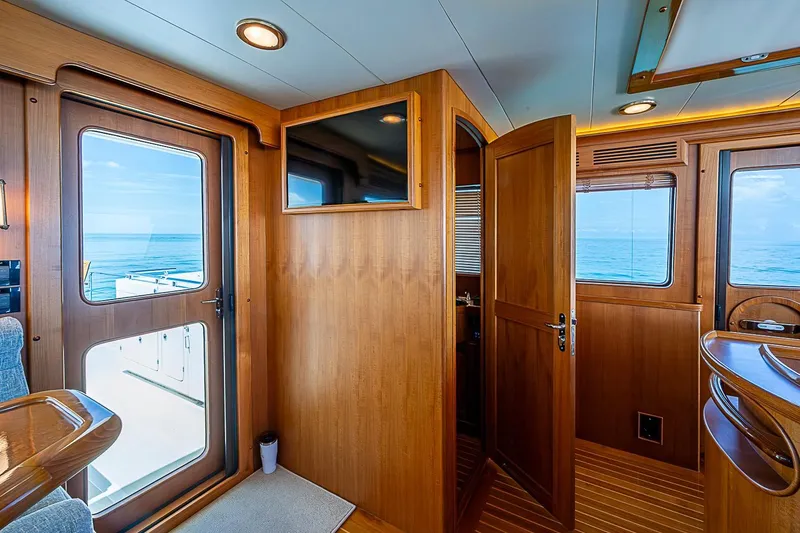 Slide: The Image of Interior of 2014 Marlow 80 Explorer yacht with wooden finishes and ocean view. - 14