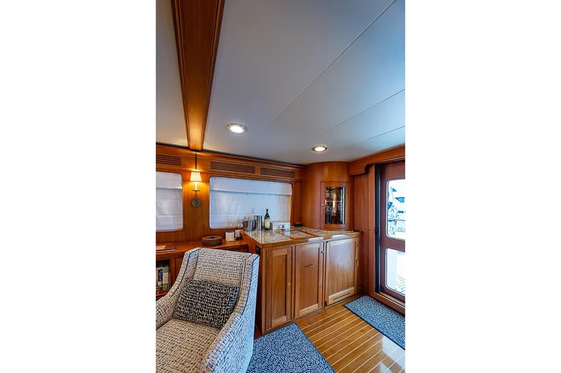 Slide: The Image of Luxurious interior of 2014 Marlow 80 Explorer yacht with wooden cabinetry and cozy seating. - 21