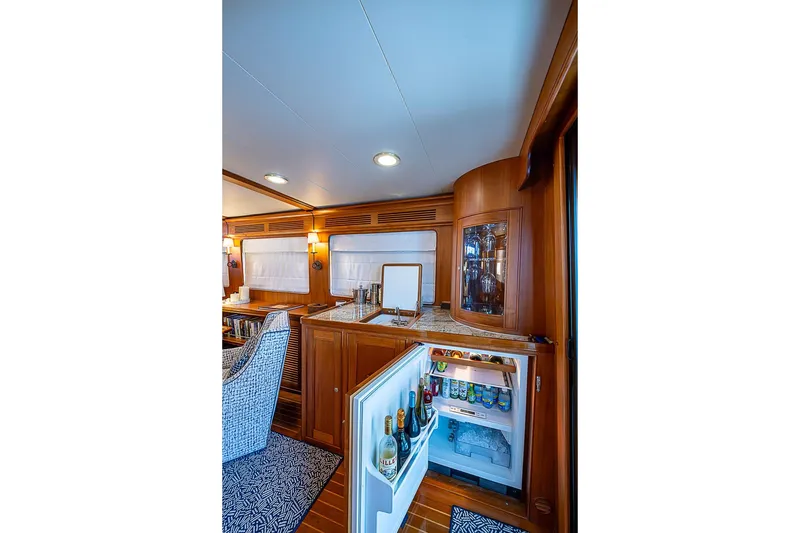Slide: The Image of Luxurious interior of 2014 Marlow 80 Explorer yacht with open fridge and elegant wood finish. - 22