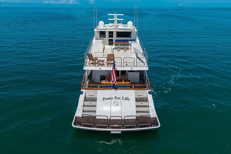 Slide: The Image of 2014 Marlow 80 Explorer yacht "Paws for Life" cruising on open sea. - 3