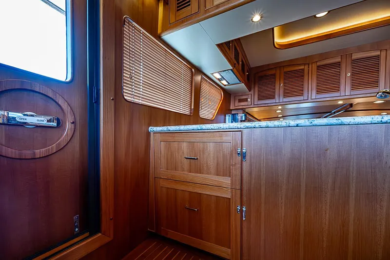 Slide: The Image of Luxurious wooden interior of 2014 Marlow 80 Explorer yacht kitchen with granite countertop. - 33