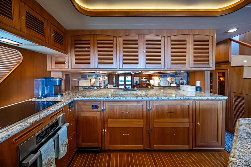 Slide: The Image of Luxurious kitchen interior of 2014 Marlow 80 Explorer yacht with wooden cabinetry and granite countertops. - 34