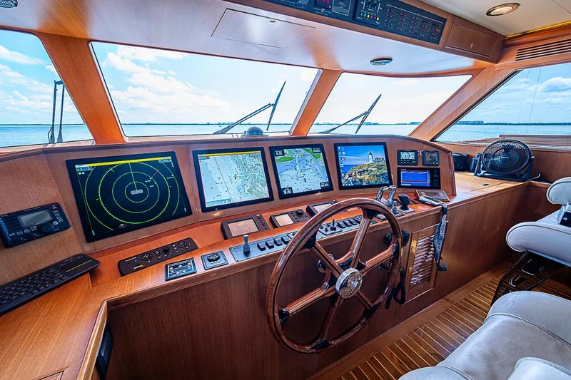 Slide: The Image of Pilothouse of 2014 Marlow 80 Explorer yacht with navigation screens and wooden steering wheel. - 4