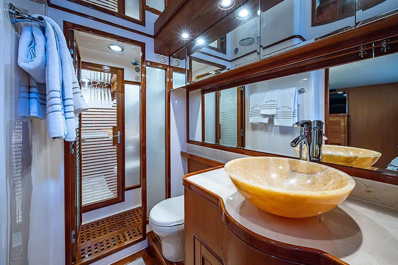Slide: The Image of Luxurious Marlow 80 Explorer 2014 yacht bathroom with elegant sink and wooden accents. - 41