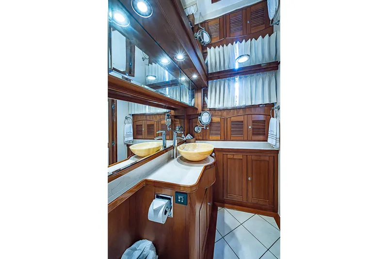 Slide: The Image of Luxurious bathroom in 2014 Marlow 80 Explorer yacht with wooden cabinetry and vessel sinks. - 43