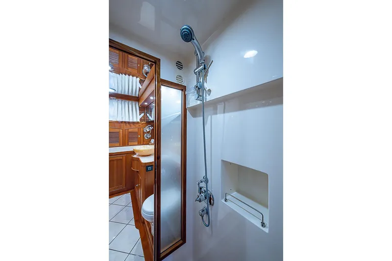 Slide: The Image of Luxurious bathroom interior of 2014 Marlow 80 Explorer yacht with wooden cabinetry and modern shower. - 44