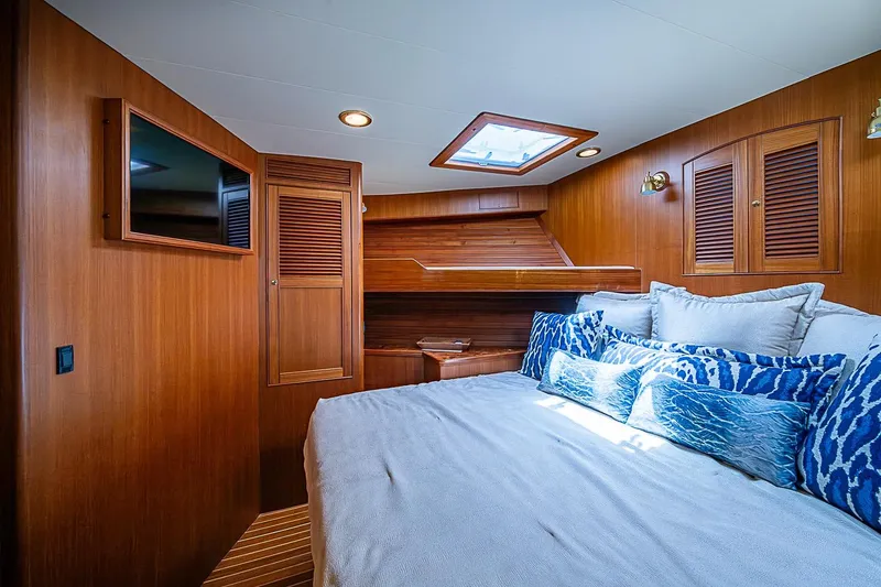 Slide: The Image of Luxurious cabin interior of 2014 Marlow 80 Explorer yacht with wood paneling and plush bedding. - 49